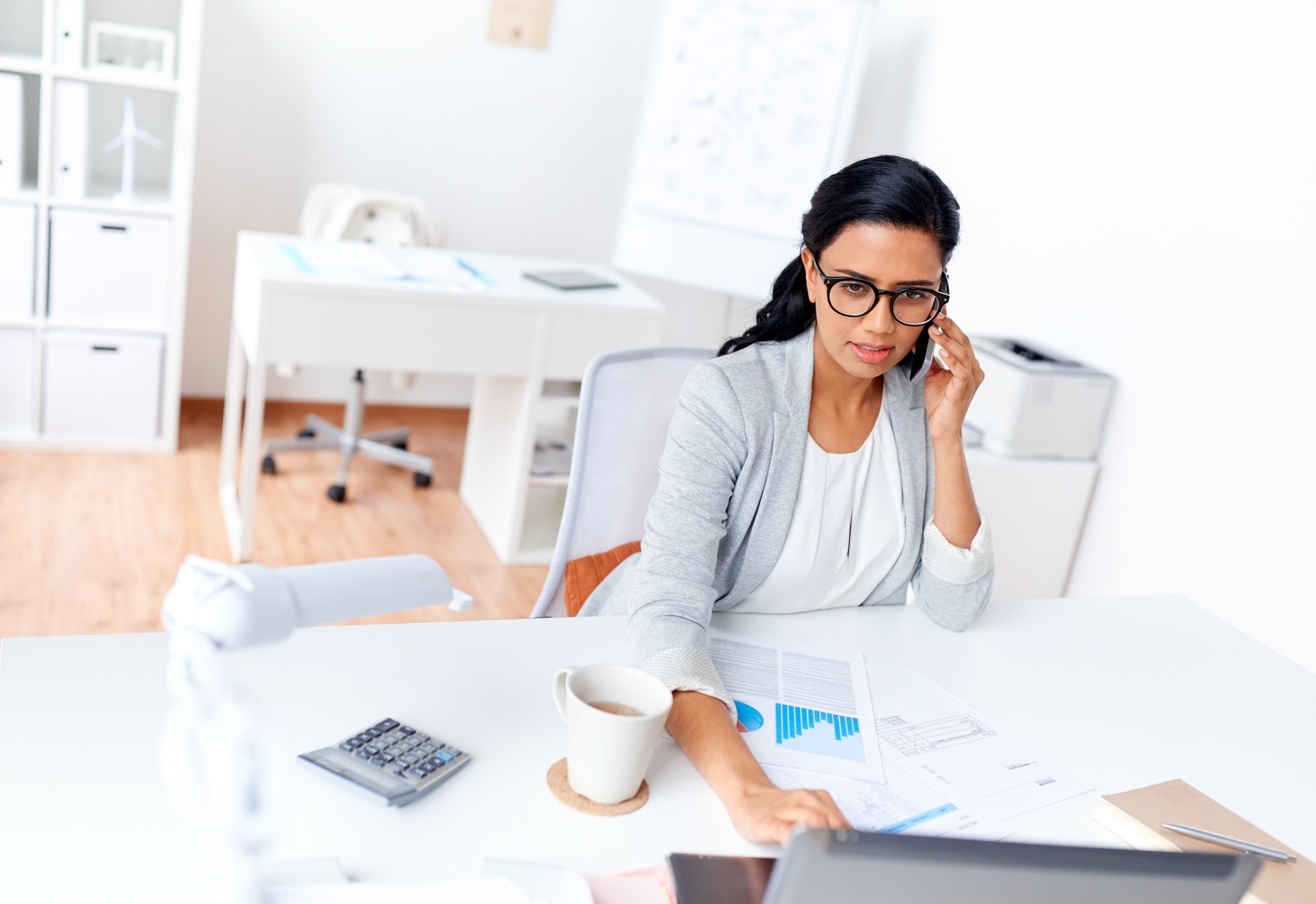 businesswoman calling on smartphone at office