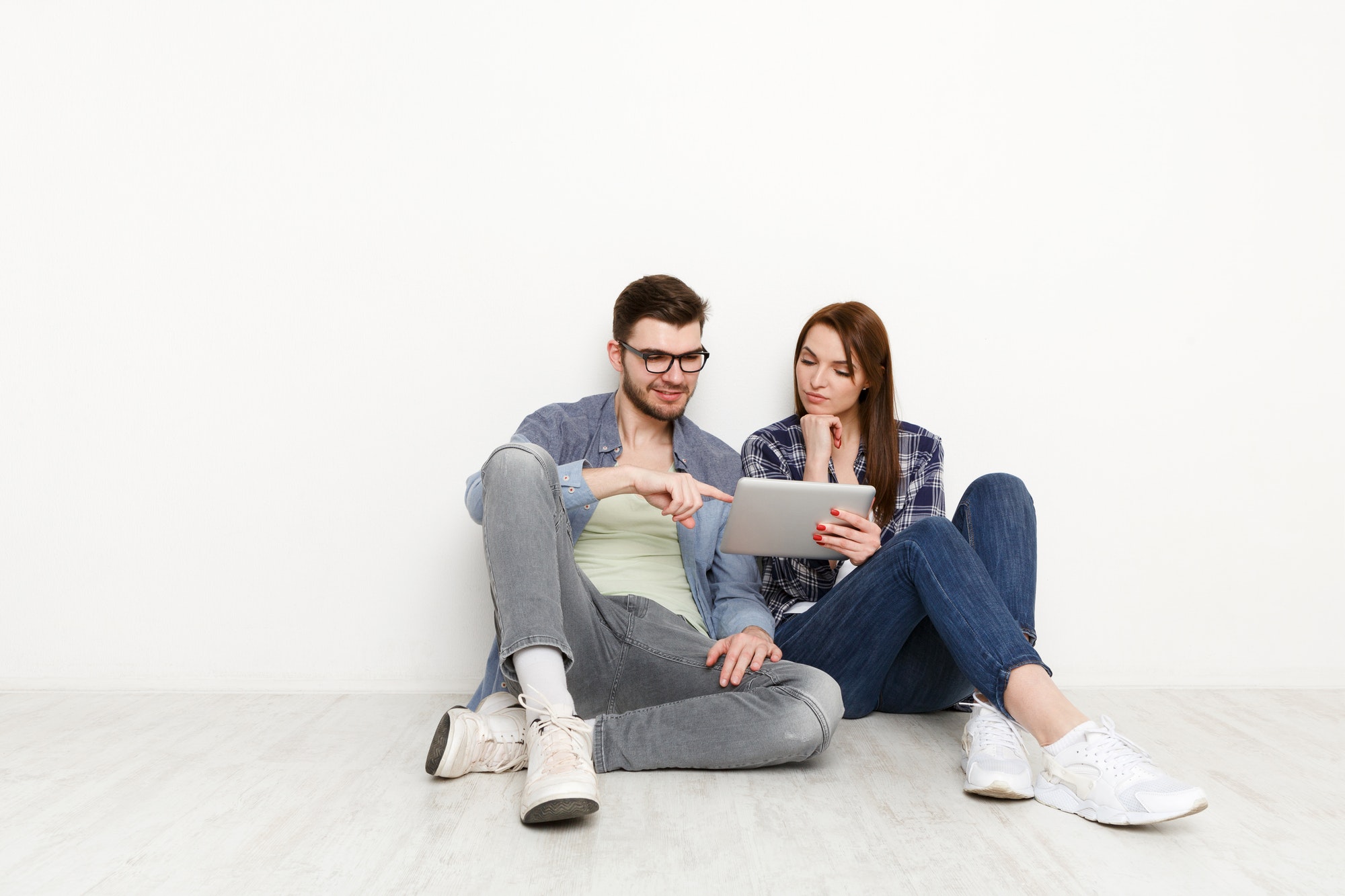 Couple ordering purchase with digital tablet