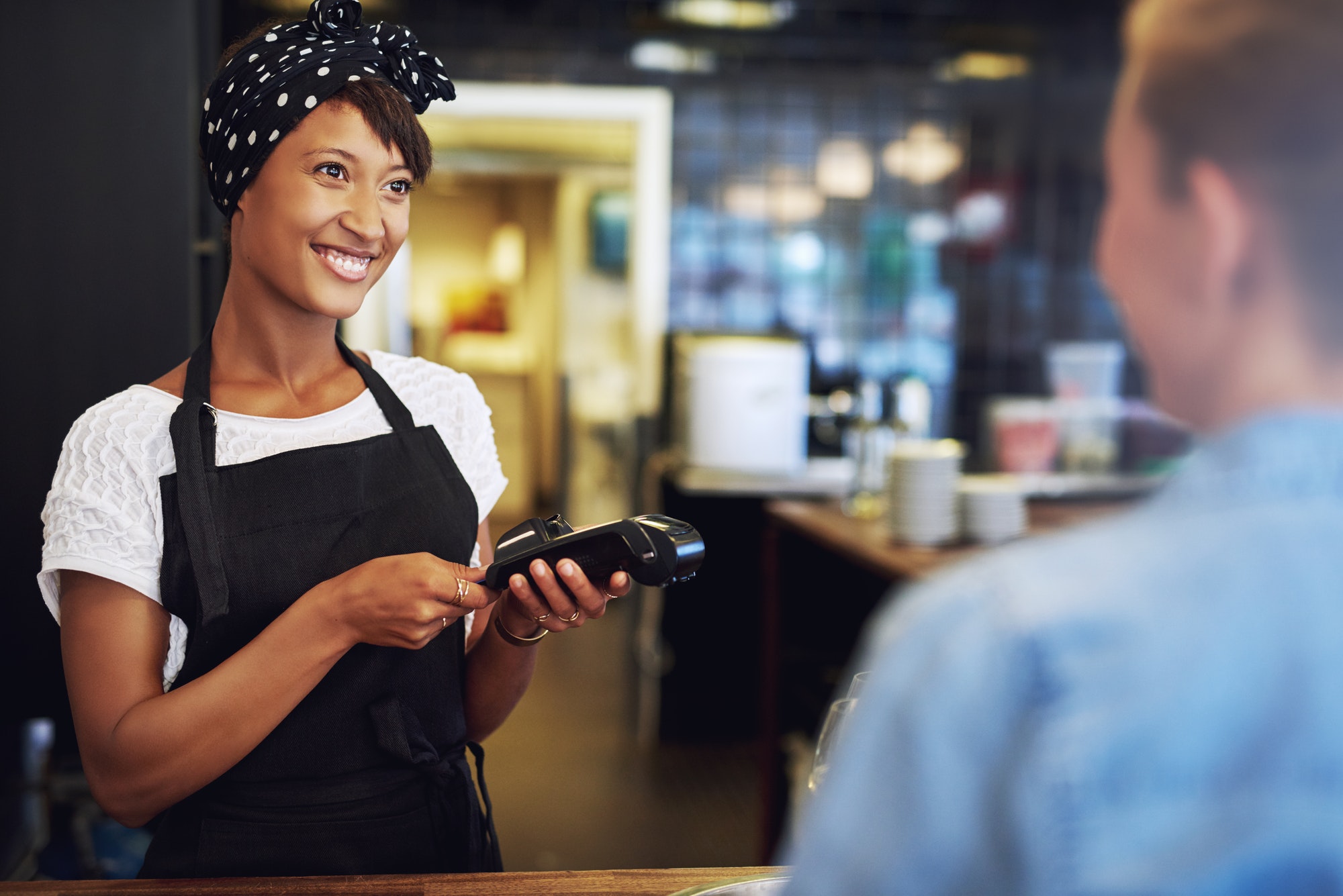 Smiling small business owner taking payment